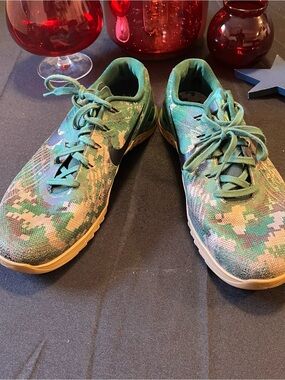 Nike green and tan shoe with black Swoosh